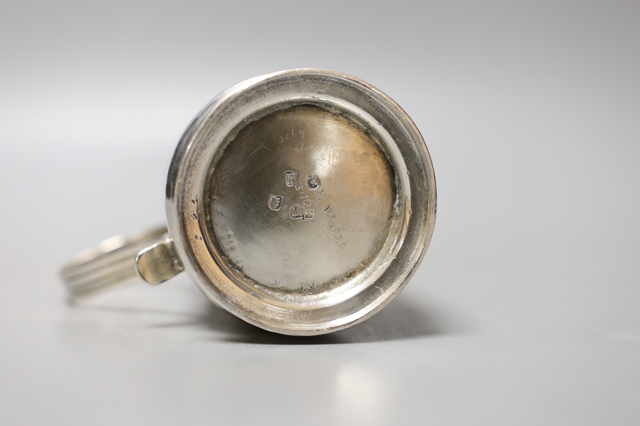 A small late George I silver mug, with reeded handle, by George Greenhill Jones, London, 1725, 77mm, 112 grams, (a.f.).